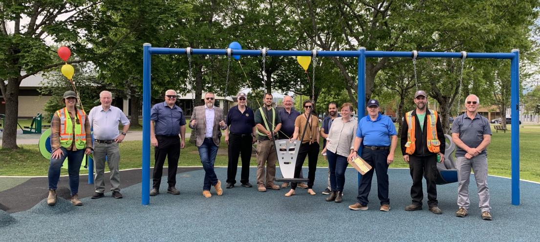 City staff and representatives from the Rotary Club of Terrace and Terrace Community Forest stand with the new playground equipment.