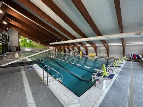 a wide angle shot of the main pool including diving board and climbing wall